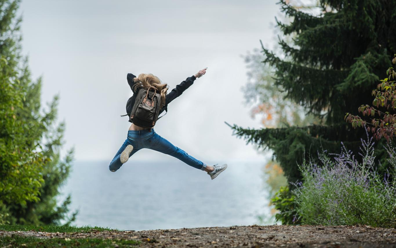 Student jumping in trees